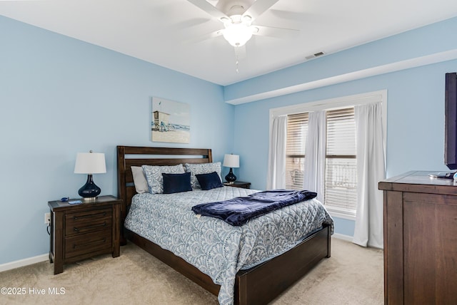 120 SE 58th St Unit 2104, Oak Island, NC 28465 - bedroom with a ceiling fan, baseboards, light colored carpet, and visible vents