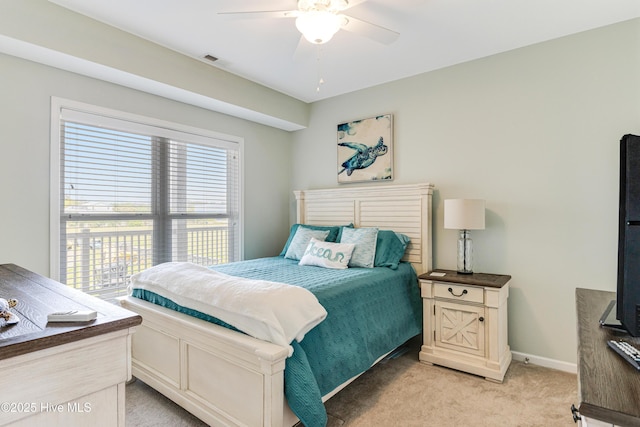 120 SE 58th St Unit 2104, Oak Island, NC 28465 - bedroom with visible vents, a ceiling fan, baseboards, and light carpet