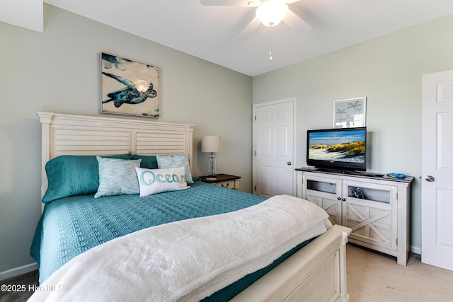 120 SE 58th St Unit 2104, Oak Island, NC 28465 - bedroom featuring a ceiling fan, baseboards, and light carpet