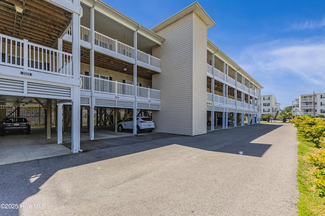 120 SE 58th St Unit 2104, Oak Island, NC 28465 - view of building exterior with covered parking