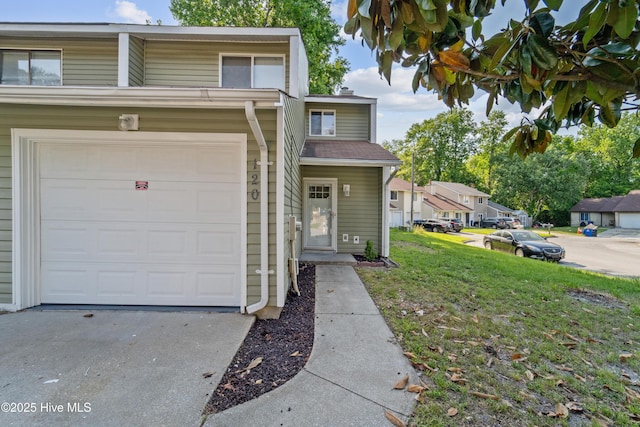 traditional-style home with a garage, a front yard, and driveway