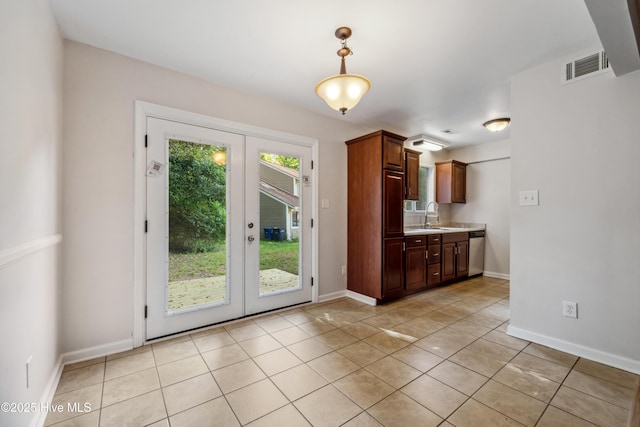 interior space featuring french doors, baseboards, light tile patterned floors, visible vents, and a sink