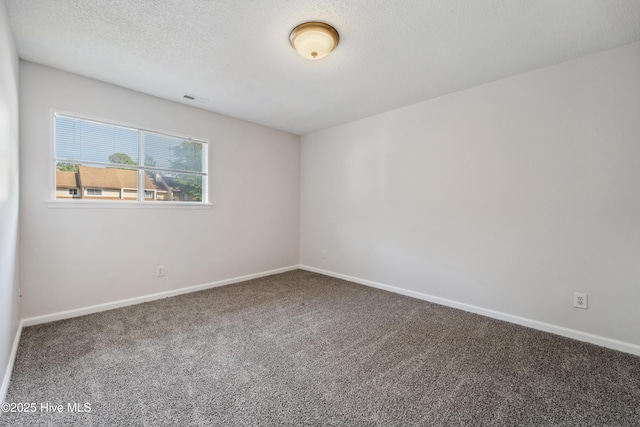 carpeted empty room with baseboards and visible vents