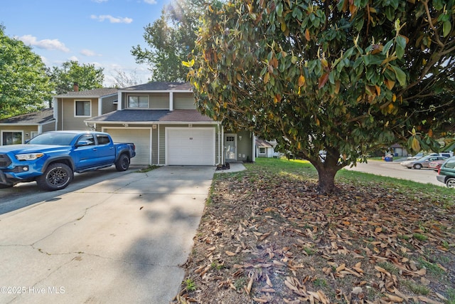 view of front of property featuring concrete driveway and a garage