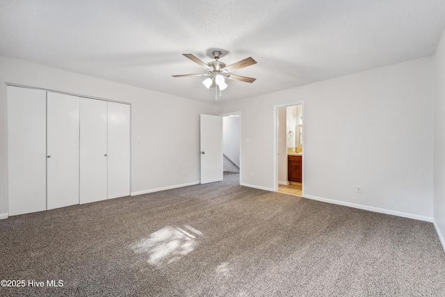 unfurnished bedroom with carpet flooring, a closet, and baseboards