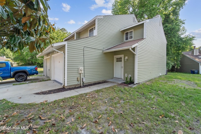 view of front of house featuring concrete driveway, an attached garage, and a front yard