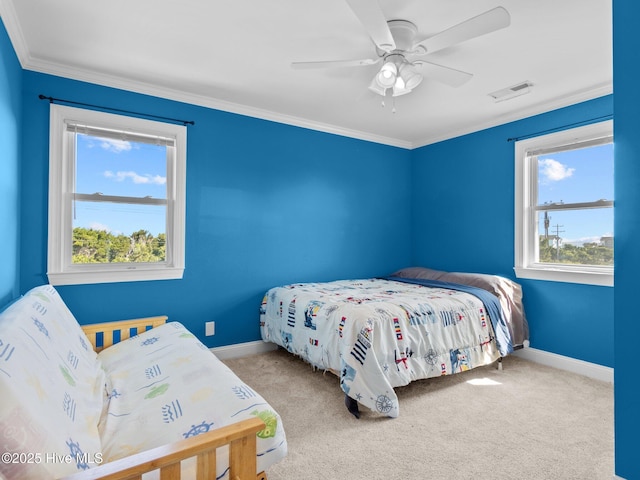 bedroom featuring carpet floors, ornamental molding, ceiling fan, baseboards, and visible vents