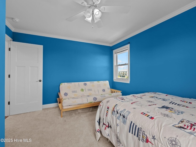 carpeted bedroom featuring ceiling fan, crown molding, and baseboards