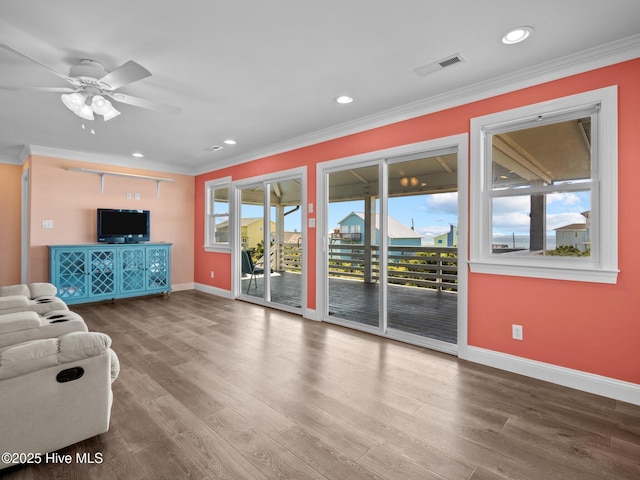 unfurnished living room featuring recessed lighting, crown molding, a ceiling fan, and baseboards