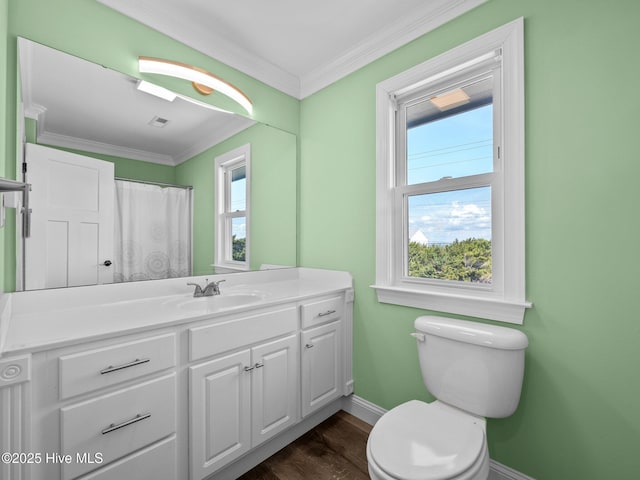 bathroom with vanity, crown molding, toilet, baseboards, and wood finished floors