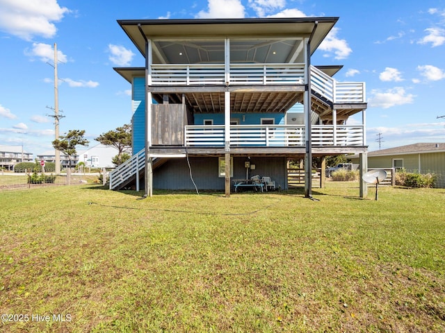 back of house with a deck, a yard, and stairway