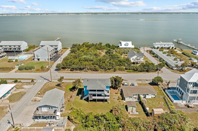 drone / aerial view with a residential view and a water view