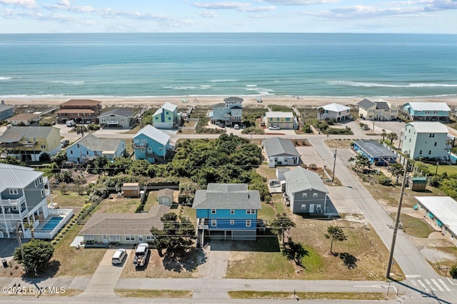 bird's eye view featuring a residential view, a view of the beach, and a water view