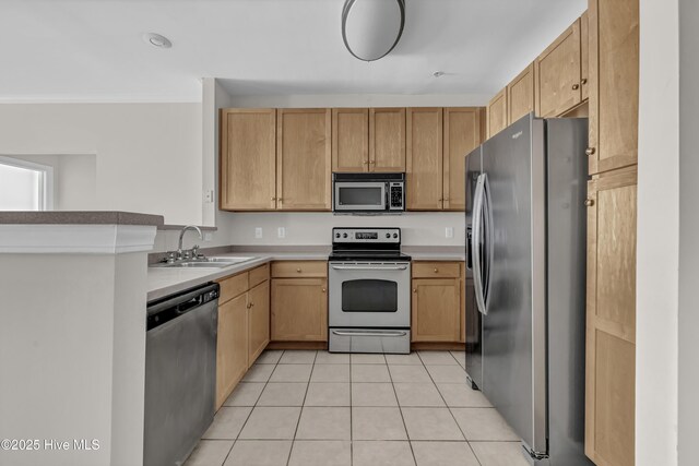 2807 Bloomfield Ln Unit 307, Wilmington, NC 28412 - kitchen with light tile patterned flooring, light brown cabinets, light countertops, a sink, and stainless steel appliances