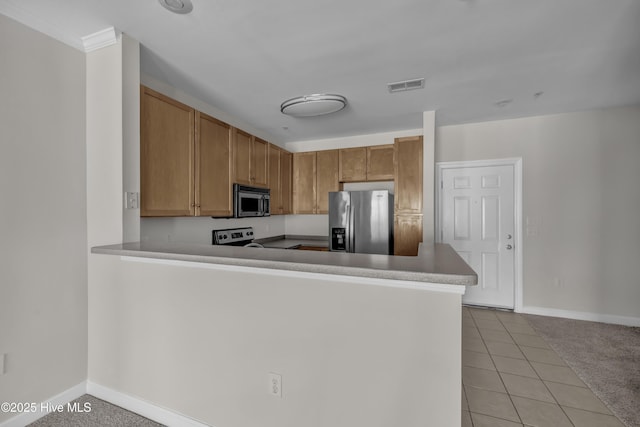 2807 Bloomfield Ln Unit 307, Wilmington, NC 28412 - kitchen featuring visible vents, a peninsula, baseboards, and appliances with stainless steel finishes