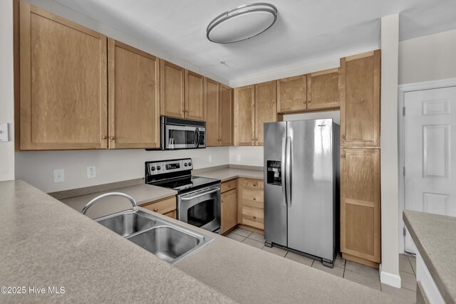 2807 Bloomfield Ln Unit 307, Wilmington, NC 28412 - kitchen featuring light countertops, stainless steel appliances, light tile patterned flooring, and a sink