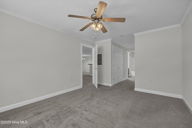 carpeted empty room featuring baseboards, a ceiling fan, electric panel, and ornamental molding