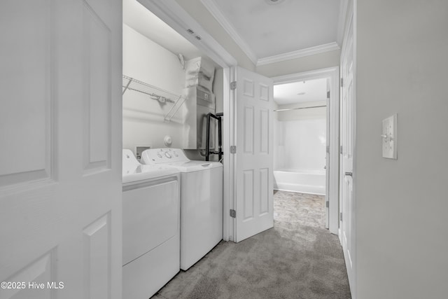 washroom with laundry area, ornamental molding, washer and dryer, and light carpet