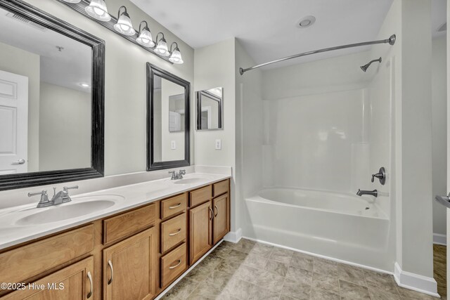 full bathroom featuring double vanity, visible vents, washtub / shower combination, and a sink