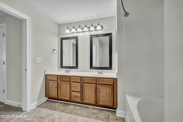 bathroom featuring a sink, baseboards, double vanity, and a tub to relax in