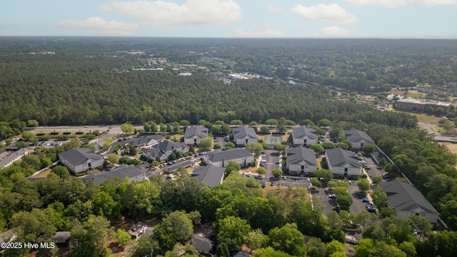 birds eye view of property with a forest view and a residential view