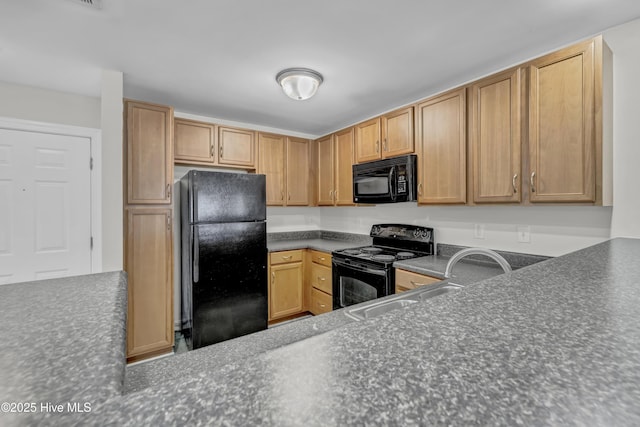 kitchen featuring a sink, dark countertops, and black appliances