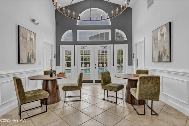 dining area with light tile patterned floors, a wealth of natural light, french doors, and visible vents
