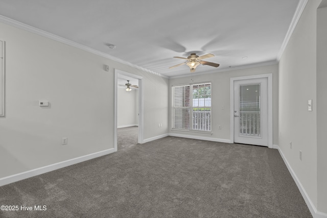 spare room with crown molding, ceiling fan, and dark carpet