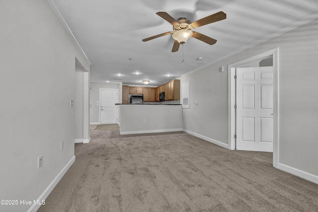 unfurnished living room with baseboards, ornamental molding, light carpet, and ceiling fan