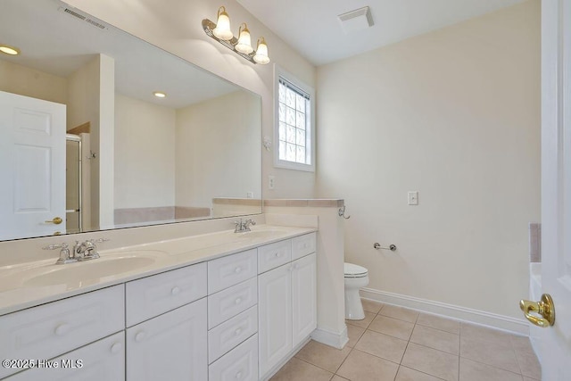 1008 Garden Club Way, Leland, NC 28451 - bathroom with baseboards, tile patterned flooring, double vanity, a shower with door, and toilet