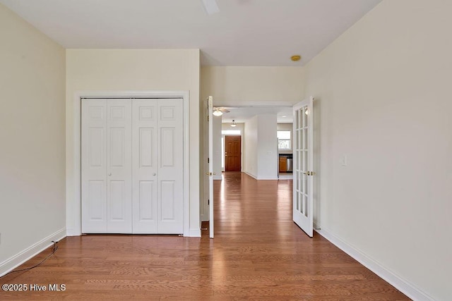 1008 Garden Club Way, Leland, NC 28451 - unfurnished bedroom featuring wood finished floors, a closet, and baseboards