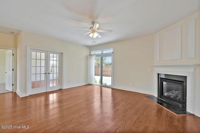 1008 Garden Club Way, Leland, NC 28451 - unfurnished living room featuring ceiling fan, light wood-style floors, a high end fireplace, and baseboards