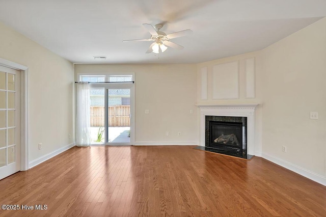1008 Garden Club Way, Leland, NC 28451 - unfurnished living room with a ceiling fan, wood finished floors, baseboards, and a fireplace