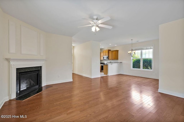 1008 Garden Club Way, Leland, NC 28451 - unfurnished living room featuring ceiling fan, baseboards, a high end fireplace, and wood finished floors