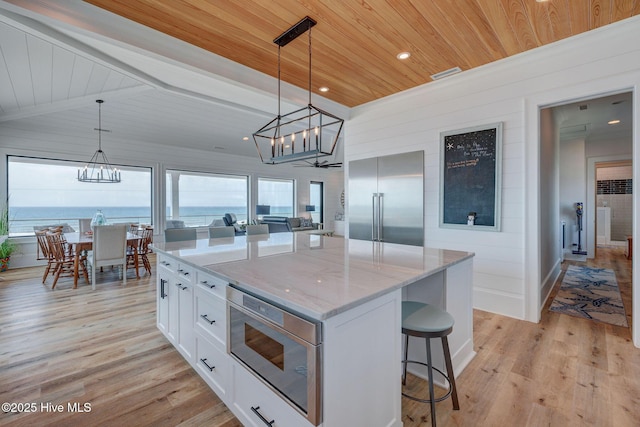 kitchen featuring wooden ceiling, a chandelier, built in appliances, white cabinets, and light wood-type flooring
