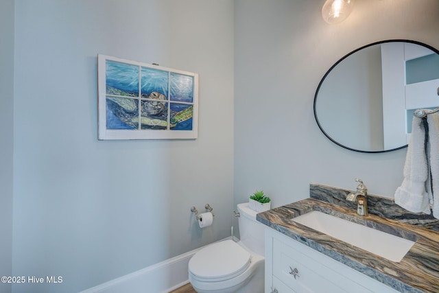 bathroom featuring toilet and vanity