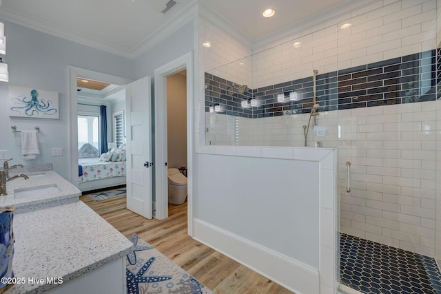 bathroom with visible vents, ensuite bathroom, ornamental molding, a walk in shower, and wood finished floors