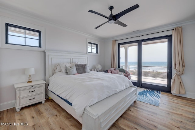 bedroom with crown molding, light wood finished floors, access to exterior, and baseboards