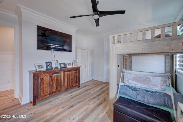 bedroom featuring wood finished floors, ornamental molding, and baseboards