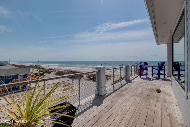 deck featuring a view of the beach and a water view