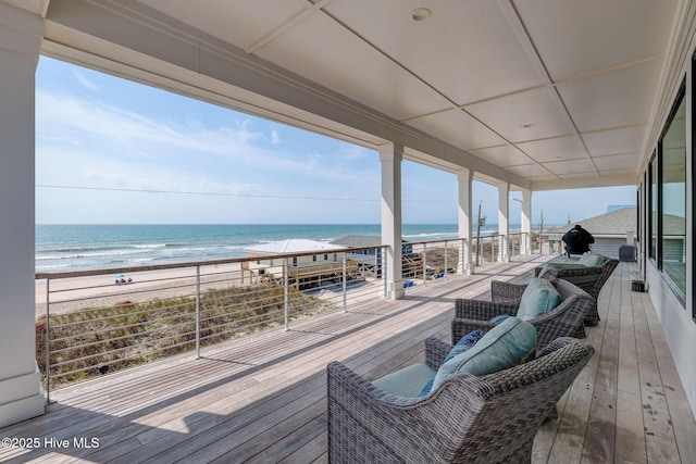 deck with a beach view and a water view