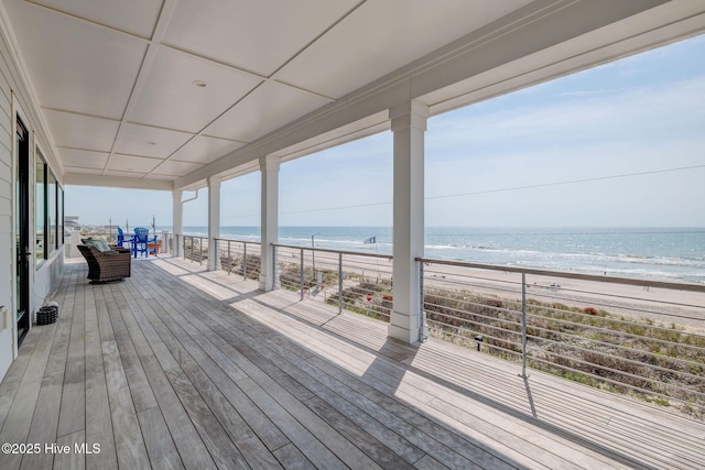 wooden terrace with a beach view and a water view