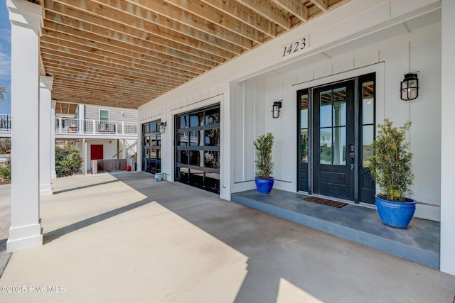 property entrance featuring board and batten siding and a baseboard radiator