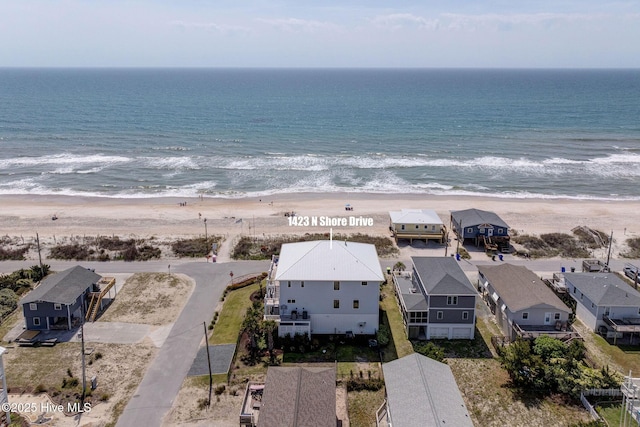 aerial view with a beach view, a water view, and a residential view