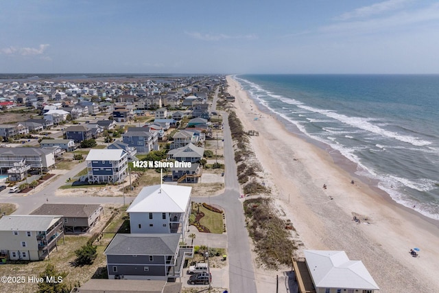 drone / aerial view with a beach view and a water view