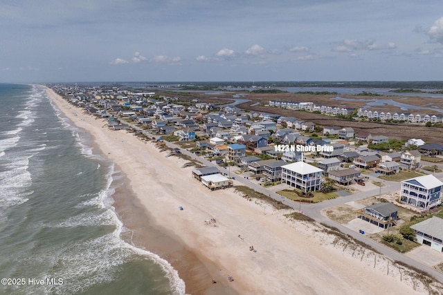 birds eye view of property with a beach view and a water view