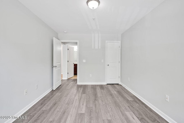 unfurnished bedroom featuring baseboards and wood finished floors