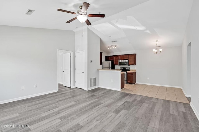 unfurnished living room featuring baseboards, ceiling fan with notable chandelier, light wood-style flooring, and visible vents