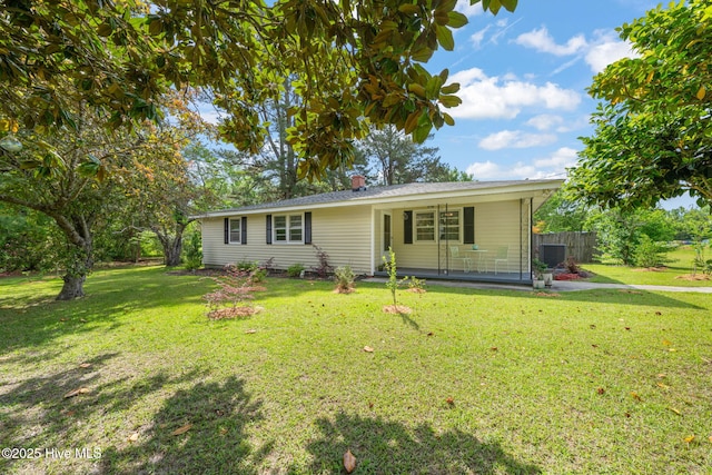 ranch-style home featuring a front lawn, central air condition unit, and fence