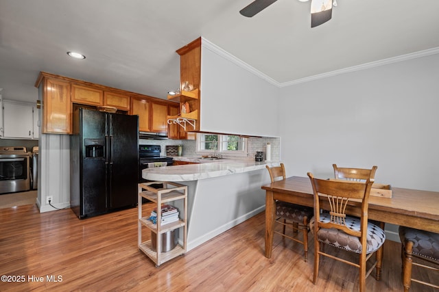 kitchen featuring black appliances, open shelves, ornamental molding, and light wood finished floors
